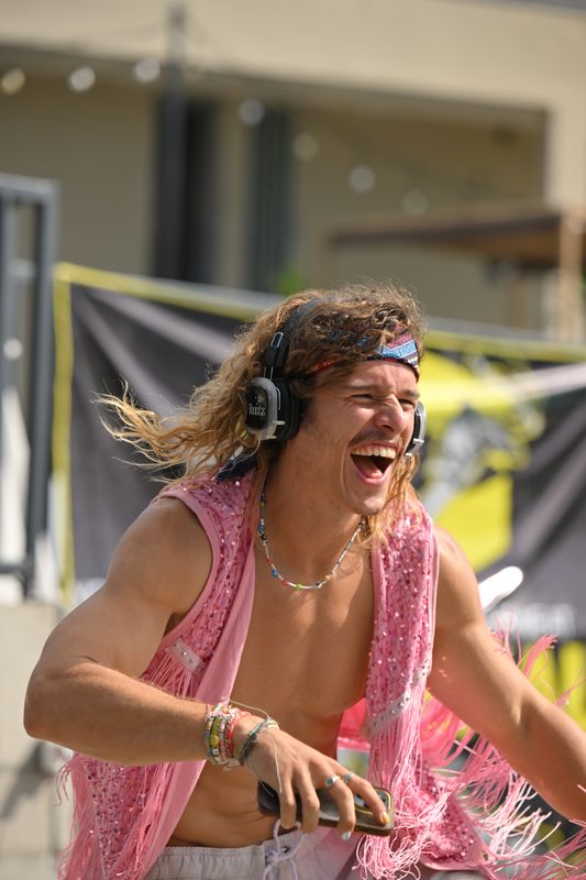 Nic Huzz, founder of Buy Silent Disco Headphones, dancing with headphones at an event
